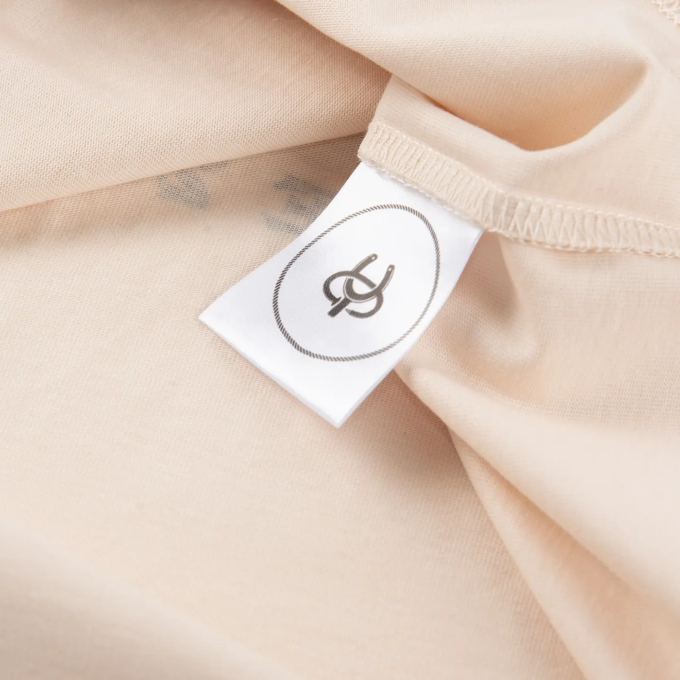 Yonder wash label sewn inside a cream T-shirt