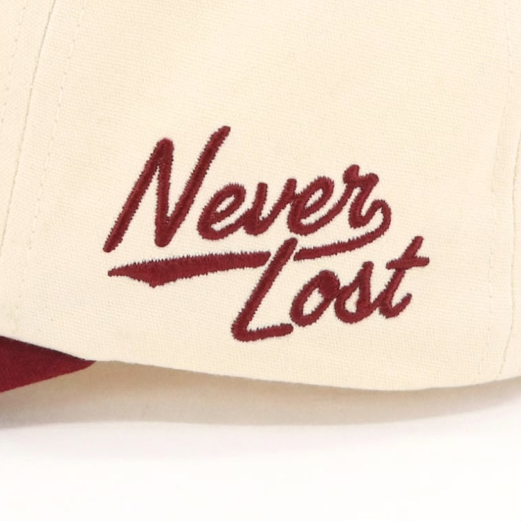 Script lettering on the side of a cream cap