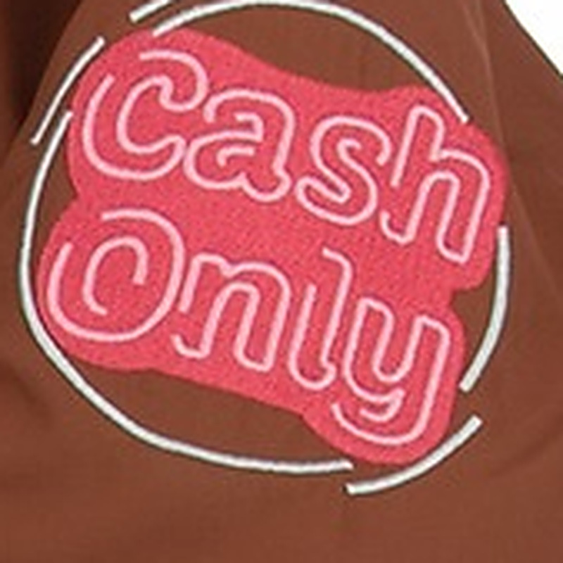 Close-up of pink Cash Only embroidery on a brown workwear jacket sleeve