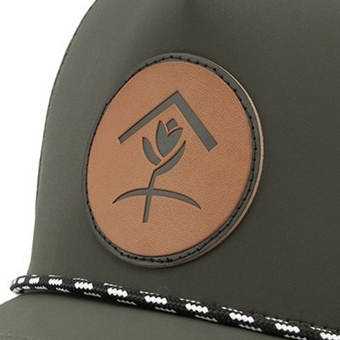 Round debossed leather patch on an olive cap