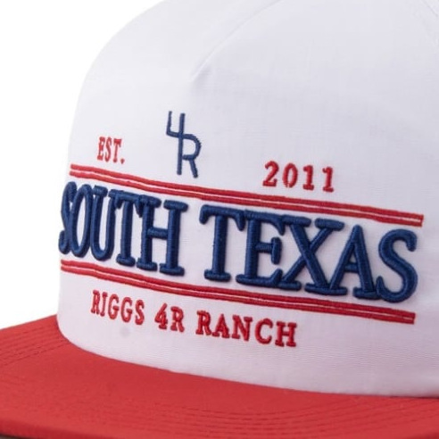 Raised puff embroidery on a white cap with a red brim