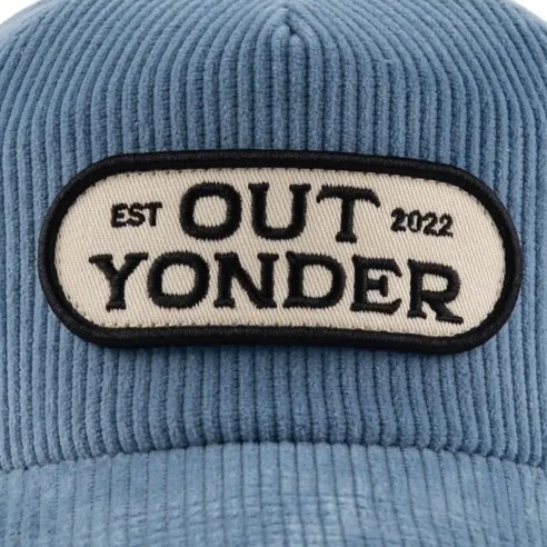 Oval woven patch on a blue corduroy cap