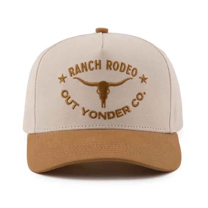 Five-panel hat, cream crown with tan suede brim, raised tan embroidery of a longhorn skull