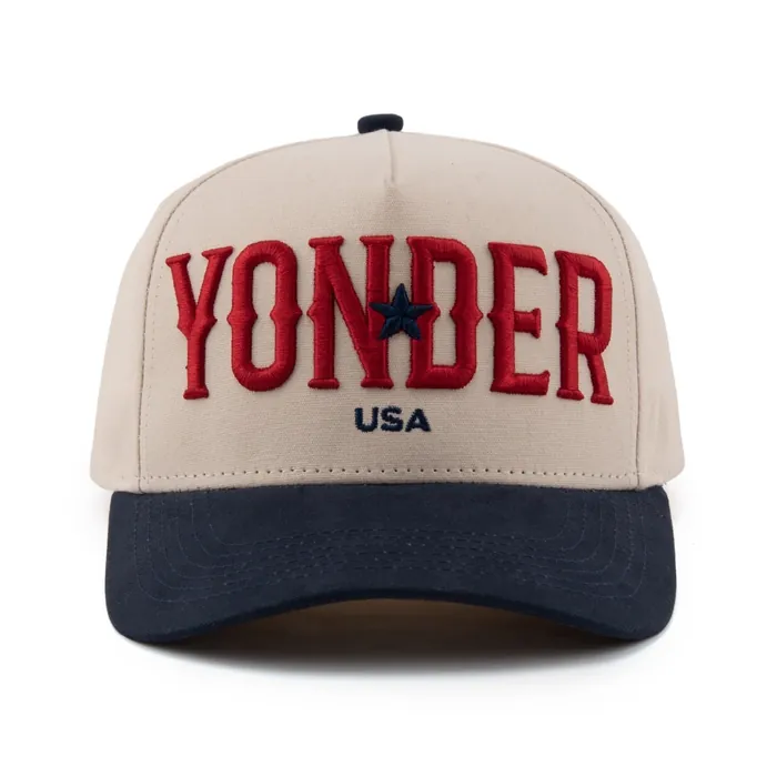 Five-panel hat, cream crown with navy brim, raised red block-letter embroidery with a navy star