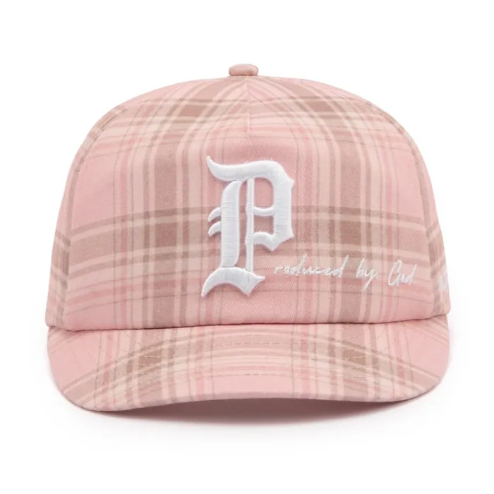 Six-panel unstructured cap in pink plaid, white embroidered gothic letter with script text, leather strap with brass buckle