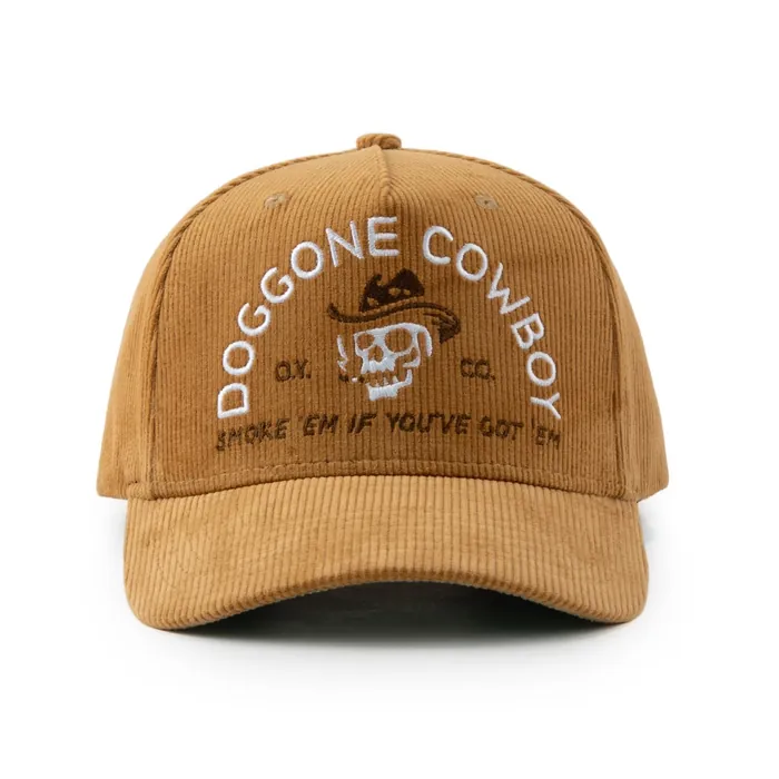 Five-panel tan corduroy hat, white embroidered arched text and skull graphic, green underbrim