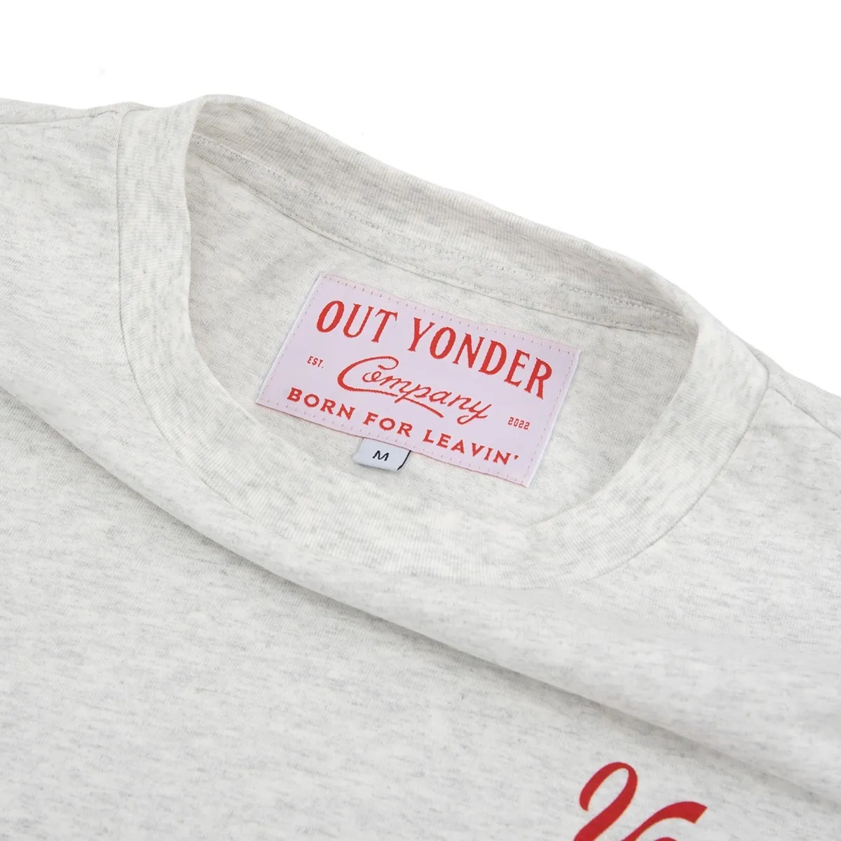 Woven neck label inside the collar of a heather gray T-shirt